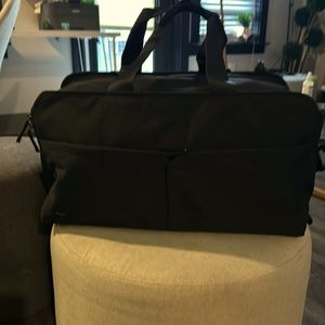 PAKT 50L GO ANYWHERE DUFFEL. 3 WAY CARRY.  CLAM SHELL OPENING, TUCK AWAY STRAPS.